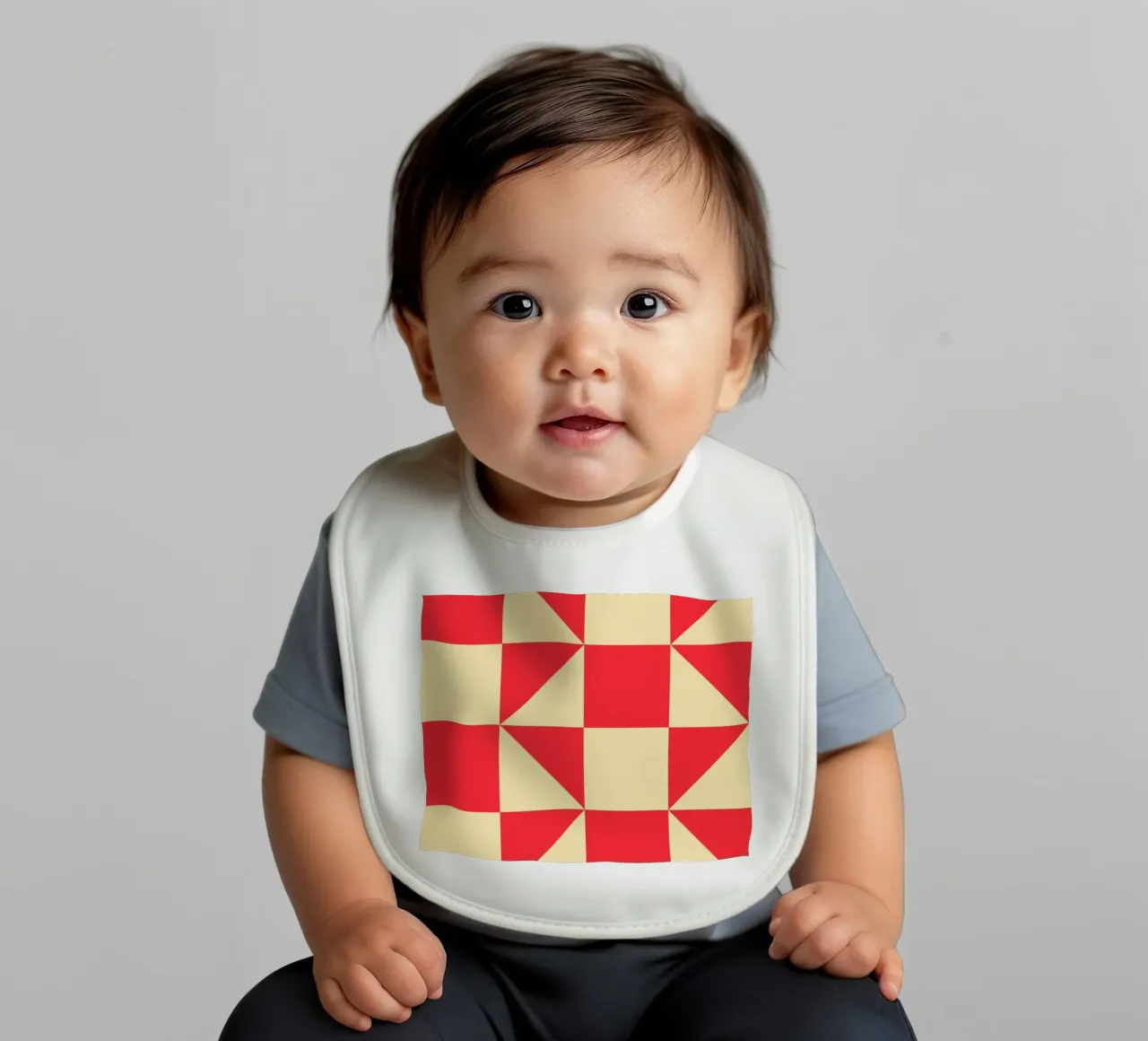 Abstract Bauhaus triangular pattern in red and cream baby bib by Casa Vibes