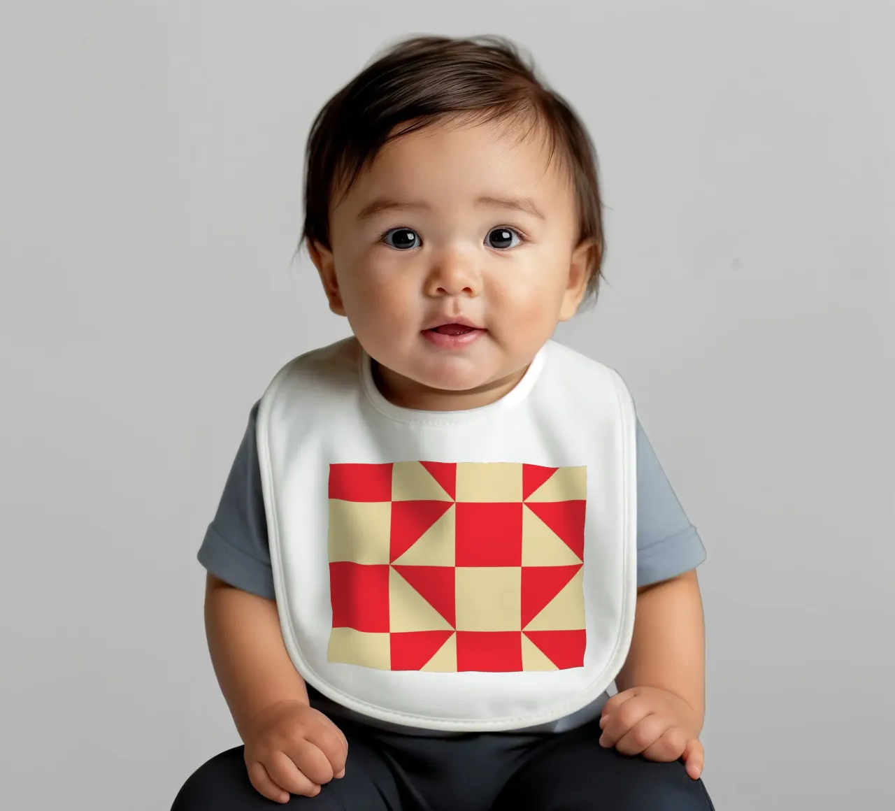Abstract Bauhaus triangular pattern in red and cream baby bib by Casa Vibes