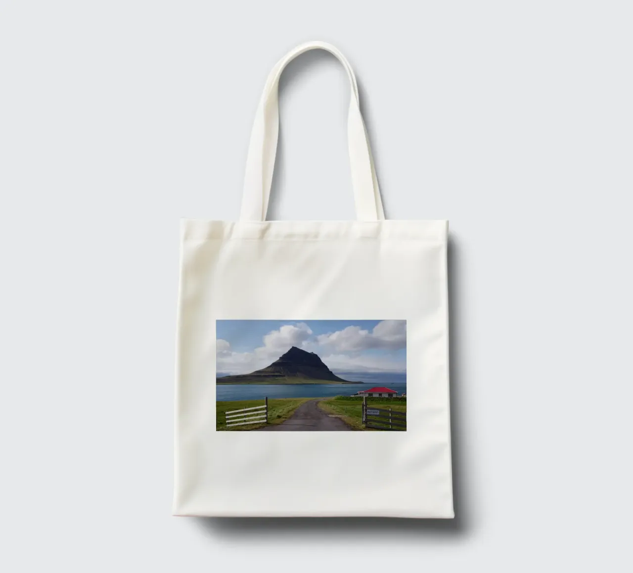 Mountain in Iceland by the sea tote bag by Fjöllart