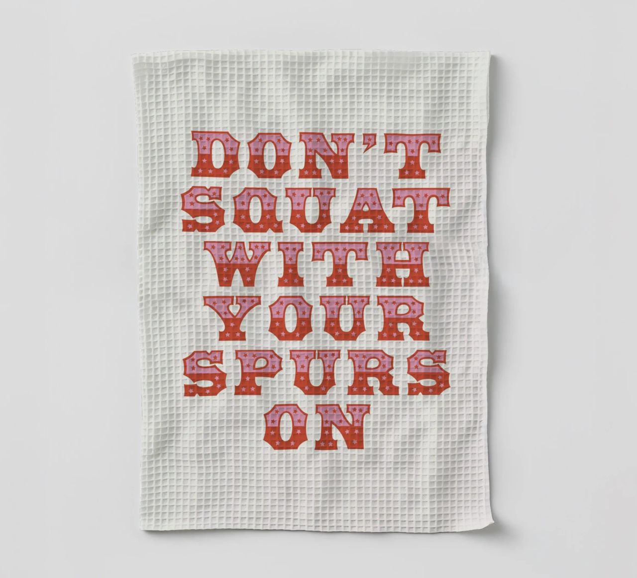 Don't Squat With Your Spurs On tea towel by The Native State