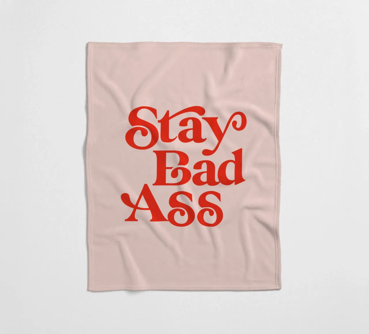 Design tipografico Stay Bad Ass in rosa e rosso coperta in pile da THE MOTIVATED TYPE
