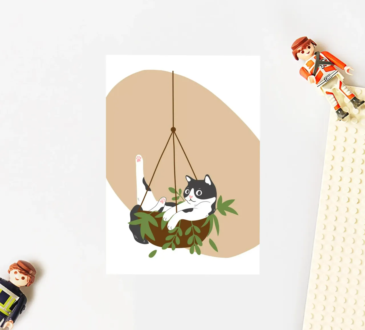 black and white cat playfully lounges in a hanging sticker by LisaArtes