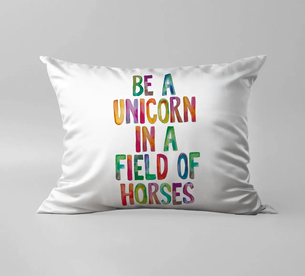 Essere un unicorno in un campo di cavalli Tipografia arcobaleno cuscino da THE MOTIVATED TYPE