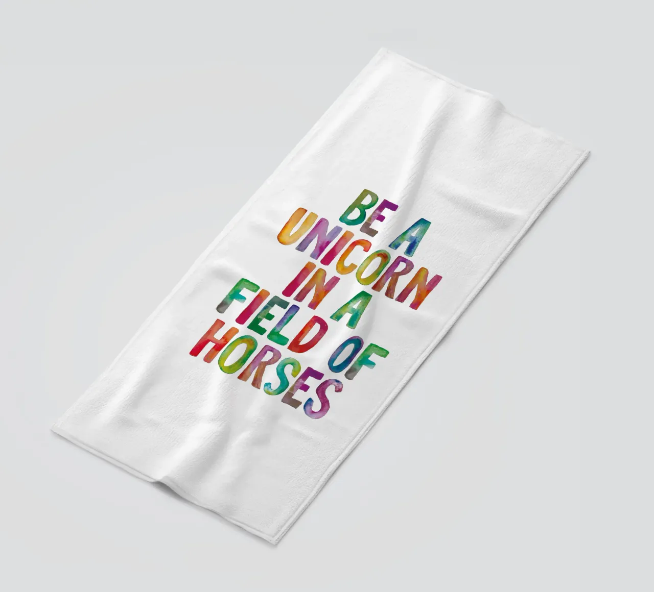 Be a Unicorn in a Field of Horses Rainbow Typography beach towel by THE MOTIVATED TYPE