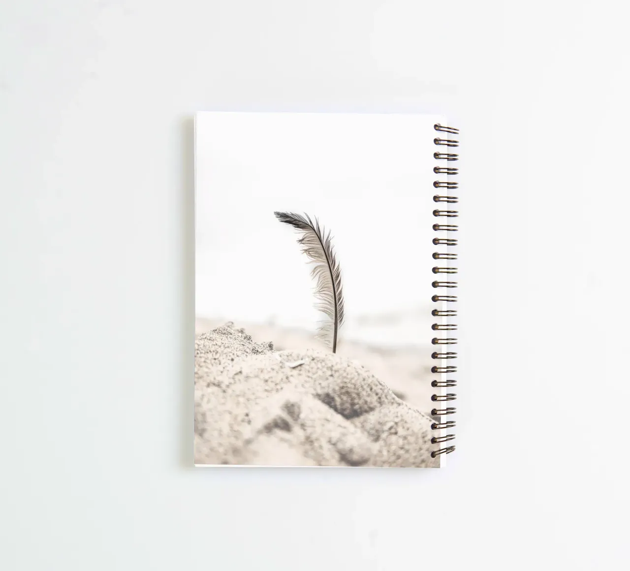 Feather in the sand - Gentle beach design spiral notebook by Whole©