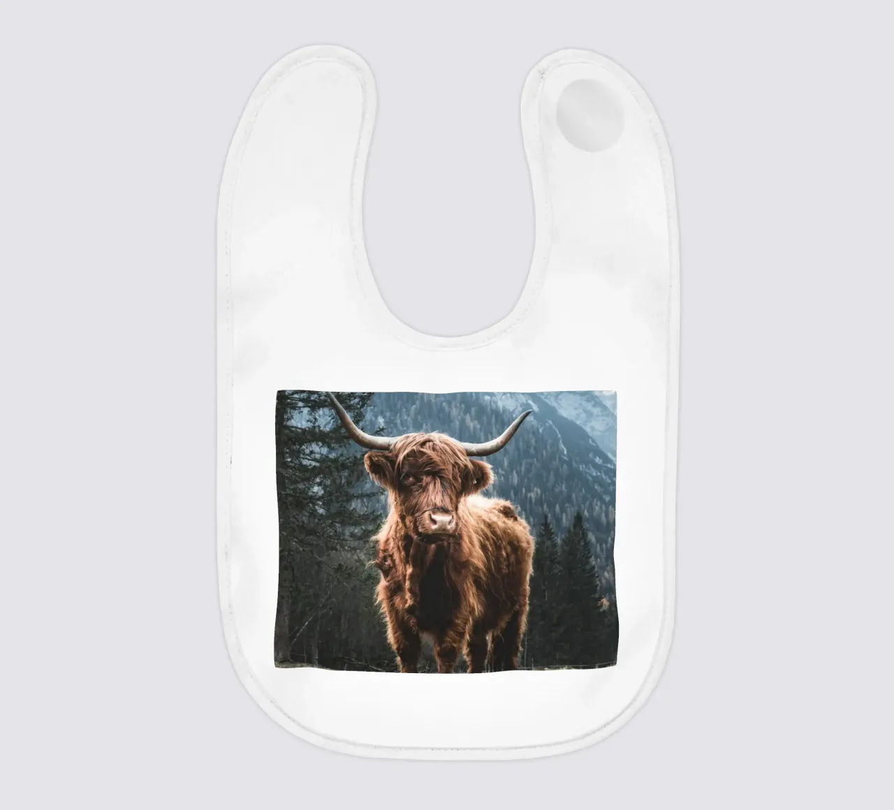 Highland cow in front of a mountain backdrop - Rustic nature photography baby bib by Whole©