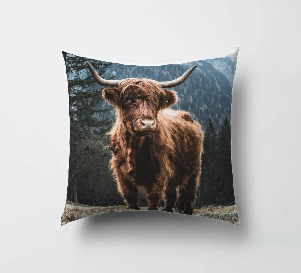 Highland cow in front of a mountain backdrop - Rustic nature photography decorative cushion by Whole©