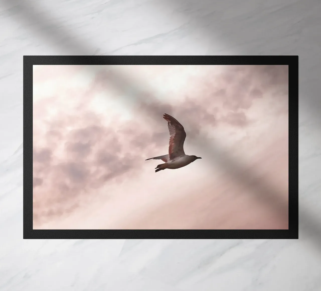 Freedom in flight - seagull in front of a rosy sky doormat by Whole©