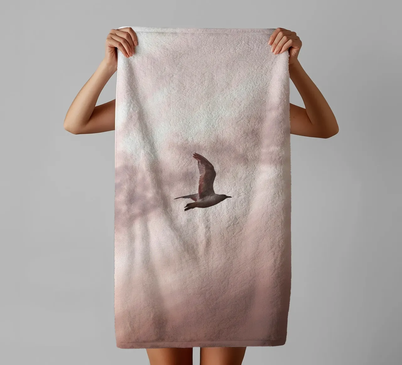 Freedom in flight - seagull in front of a rosy sky towel by Whole©