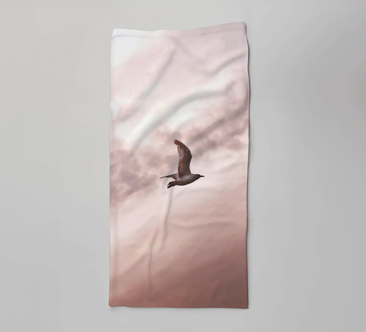 Freedom in flight - seagull in front of a rosy sky towel by Whole©