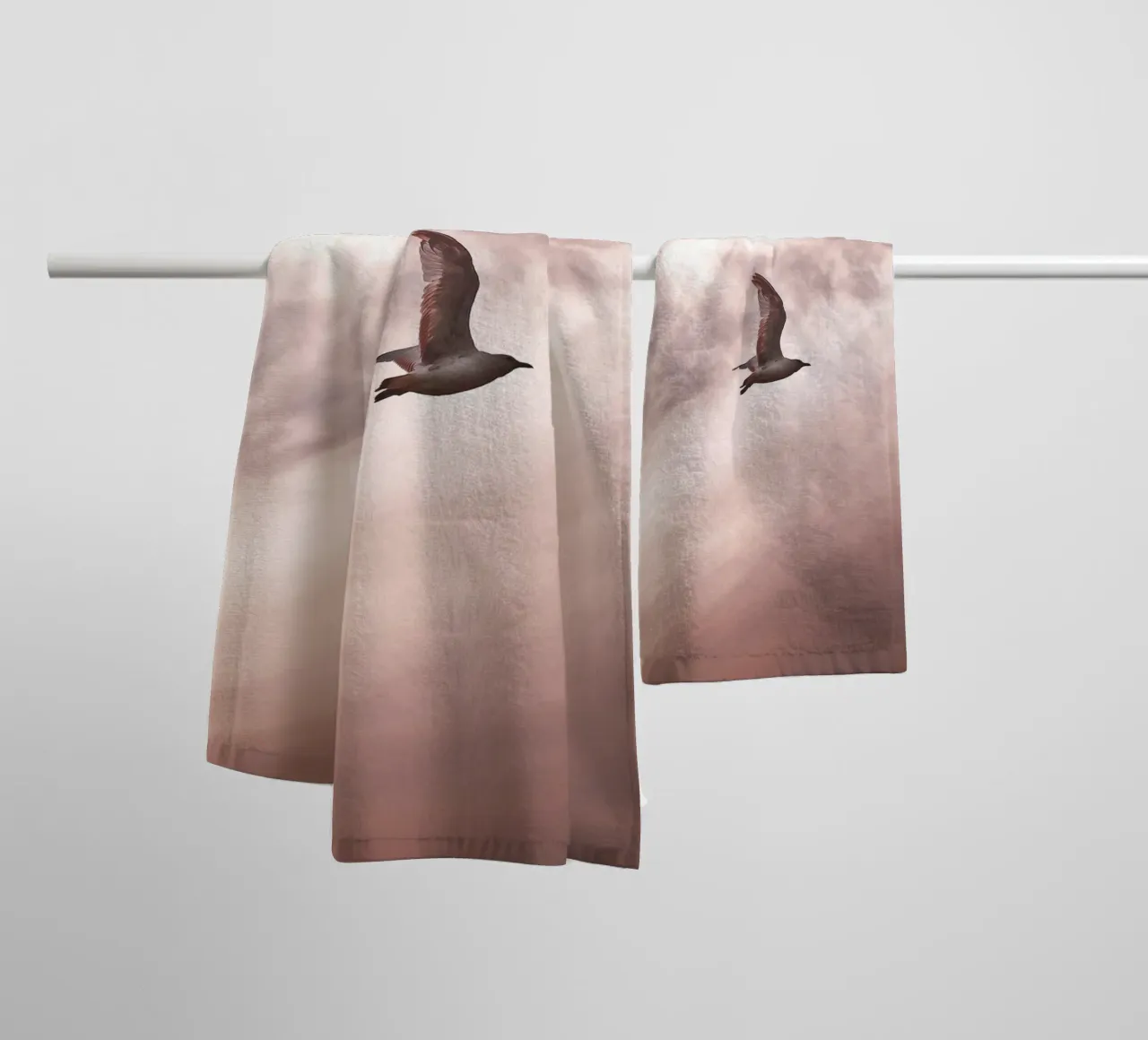 Freedom in flight - seagull in front of a rosy sky towel by Whole©
