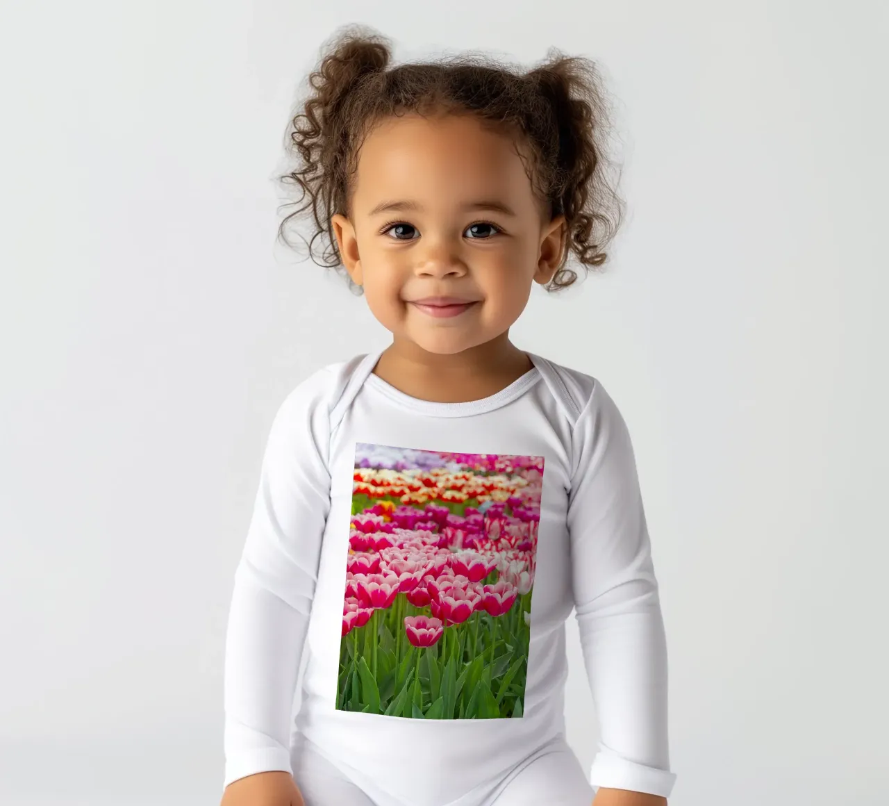 Fields of Joy: Vibrant Tulips in Bloom long-sleeve baby romper by Curious Collections by Marielle Leenders