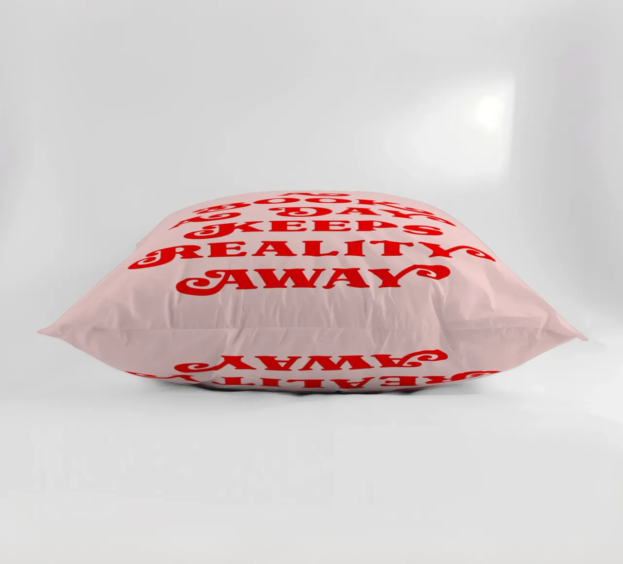 A book a day keeps reality away quote decorative cushion by Paigaam Studio