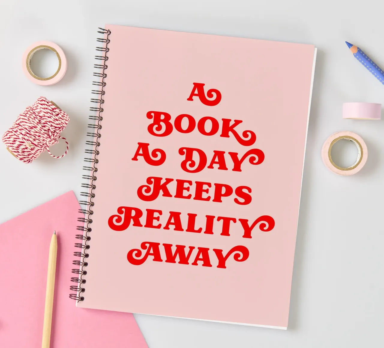 A book a day keeps reality away quote spiral notebook by Paigaam Studio