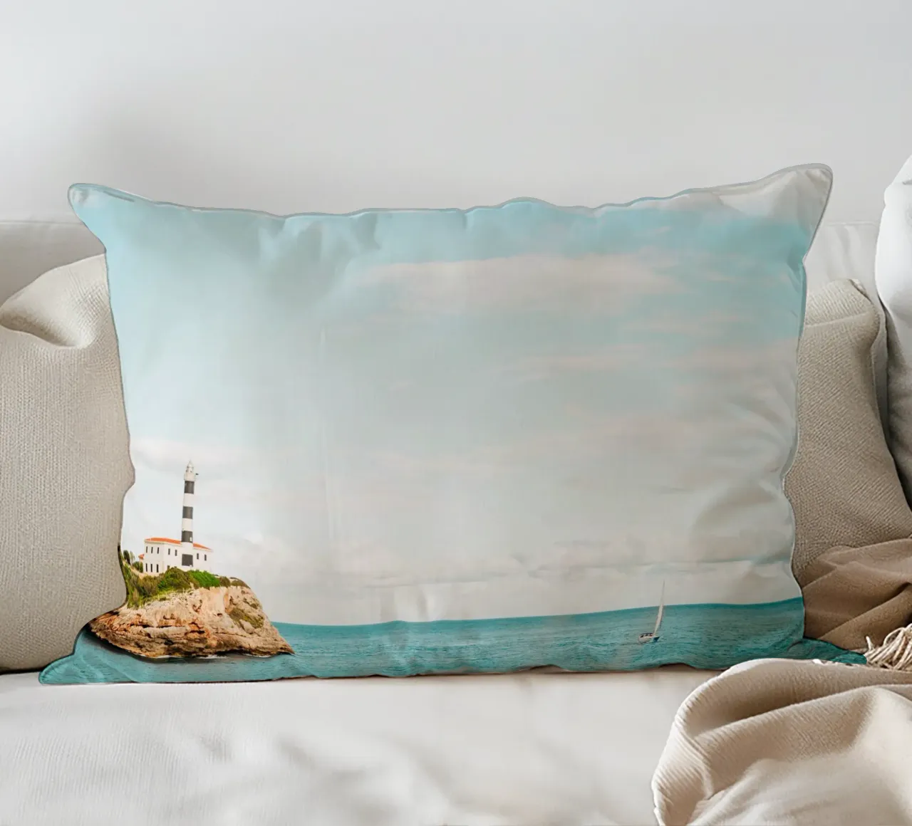 Lighthouse by the sea off Mallorca with sailing boat decorative cushion by Bold and Retro