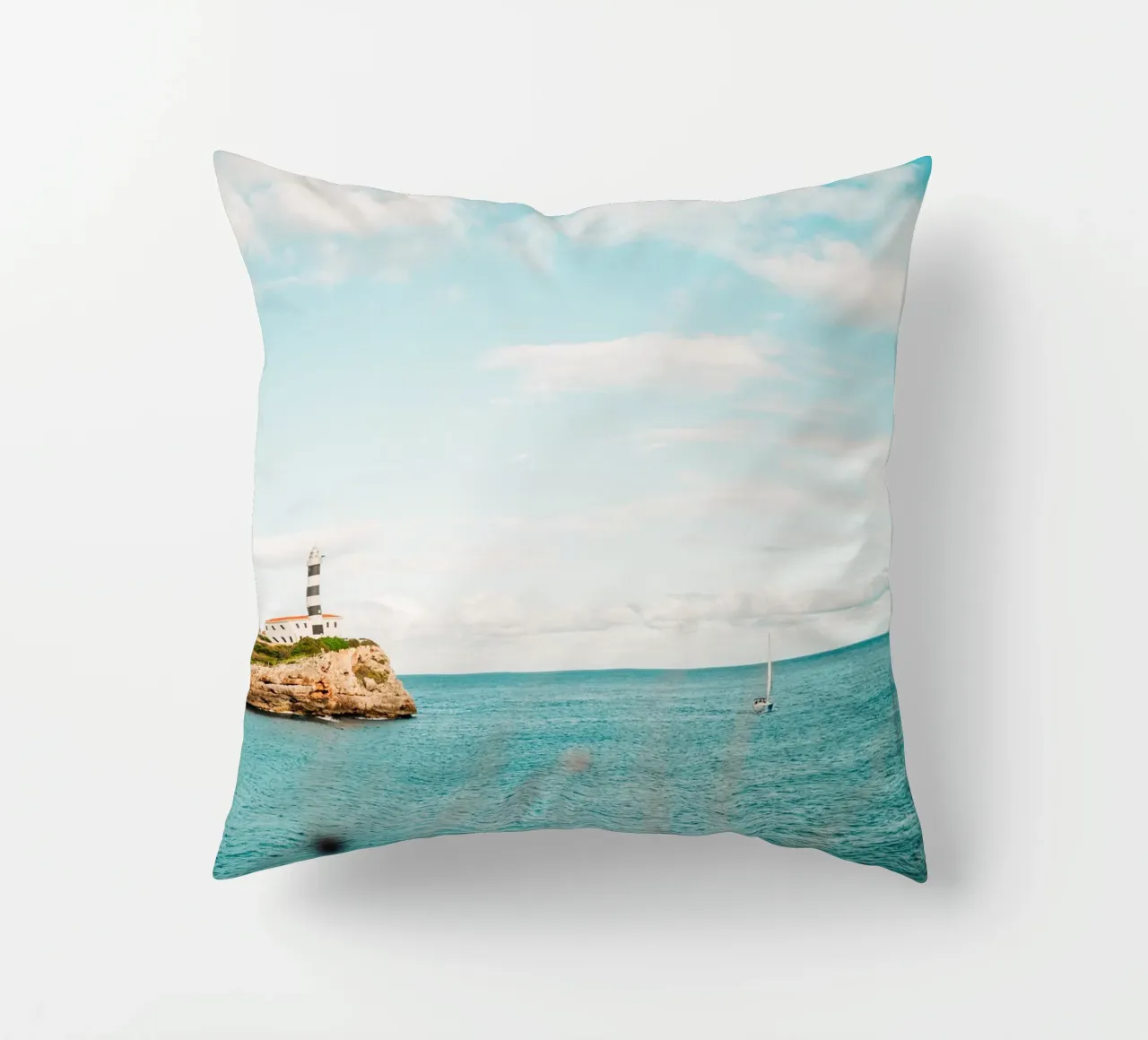 Lighthouse by the sea off Mallorca with sailing boat decorative cushion by Bold and Retro