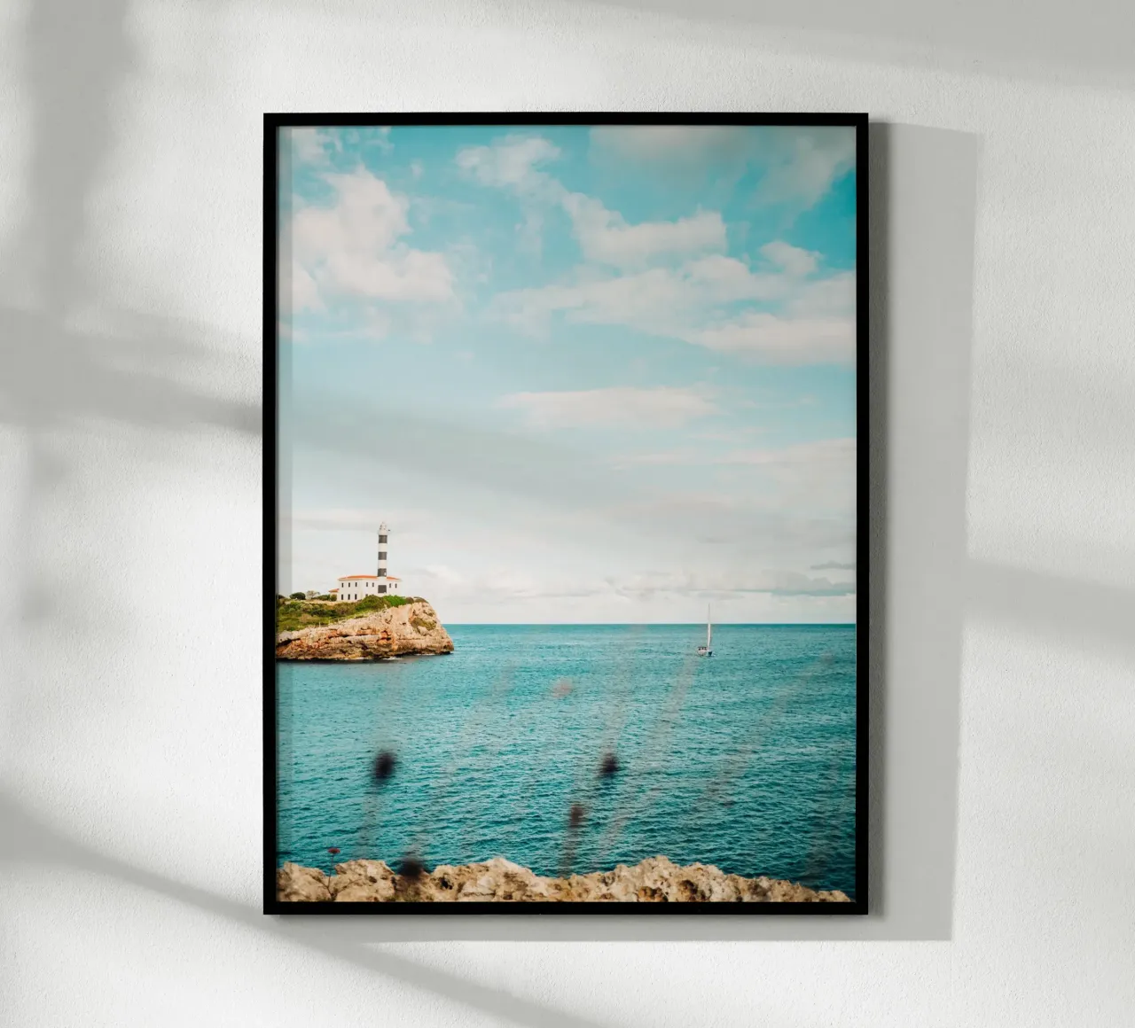 Lighthouse by the sea off Mallorca with sailing boat hahnemühle by Bold and Retro
