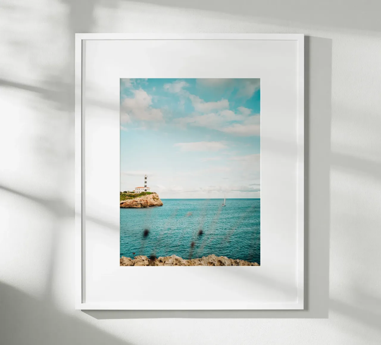 Lighthouse by the sea off Mallorca with sailing boat hahnemühle by Bold and Retro