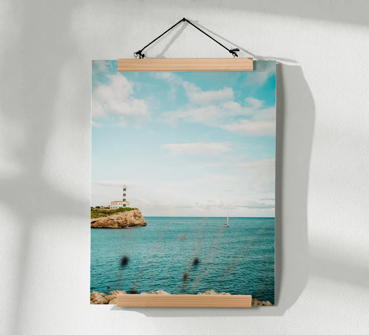 Lighthouse by the sea off Mallorca with sailing boat hahnemühle by Bold and Retro