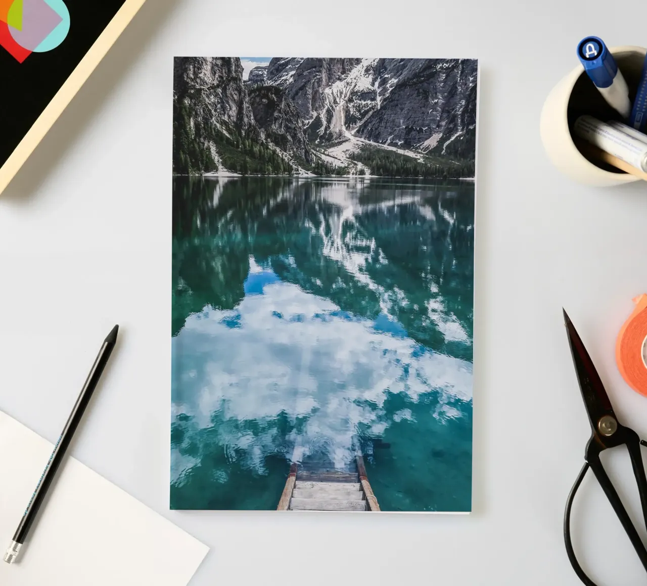 Reflecting mountain lake with jetty notebook by Whole©