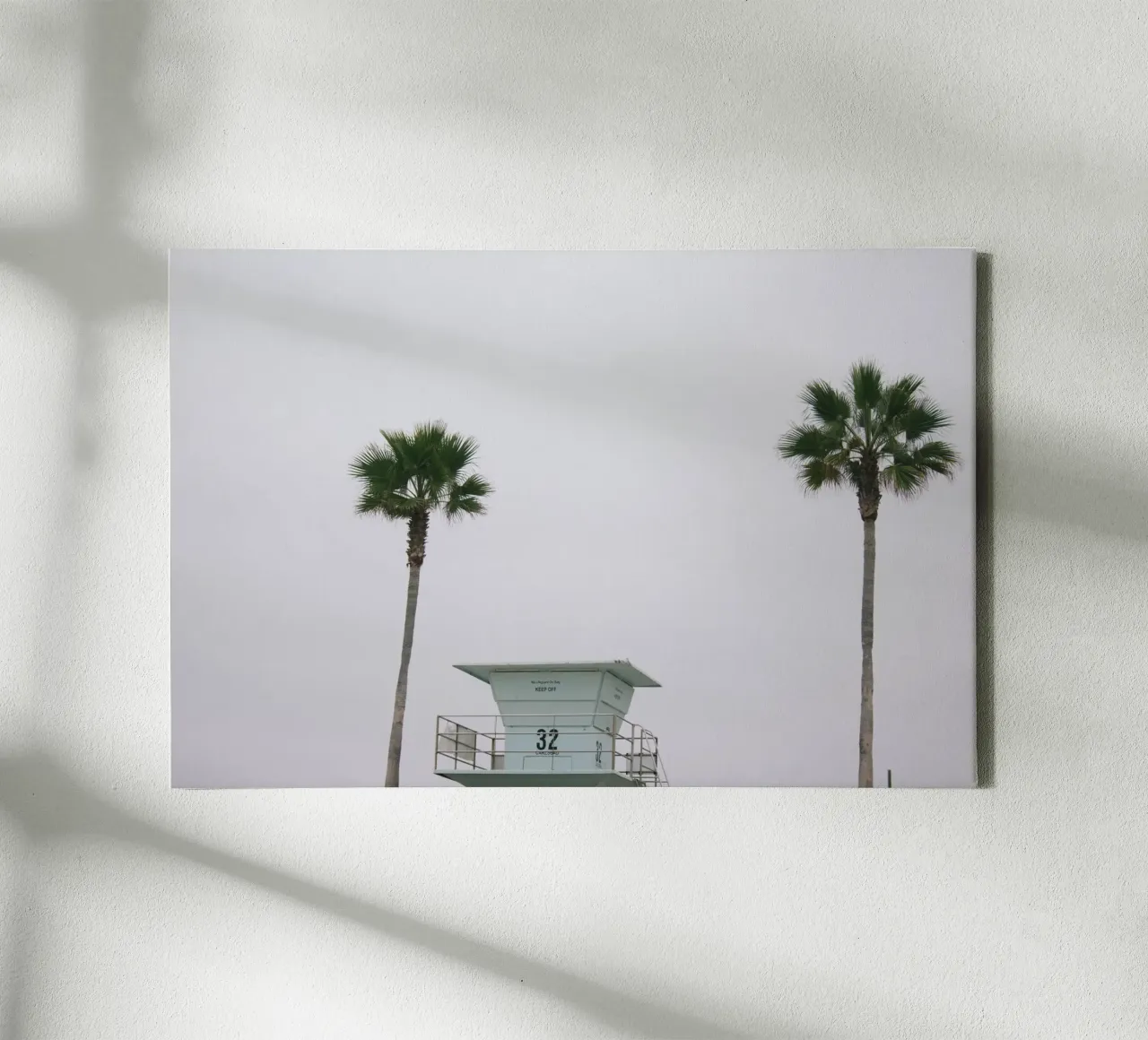 Lifeguard unter Palmen Leinwand von The Wild Creative Studio