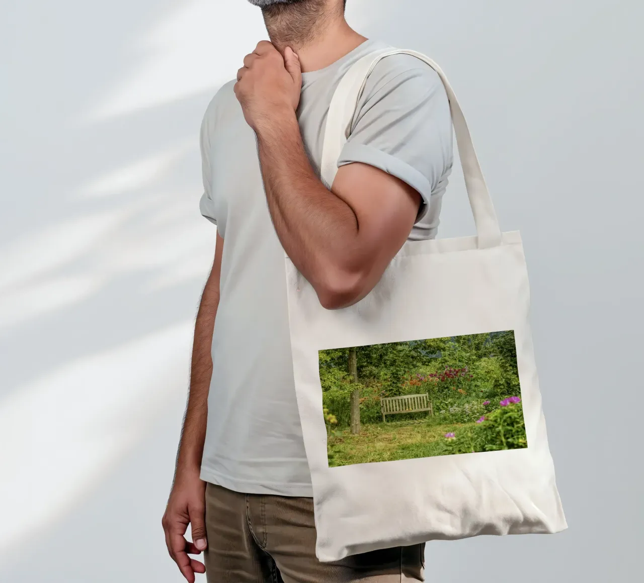 Bench nestled within a vibrant flower garden borsa in juta da Curious Collections by Marielle Leenders