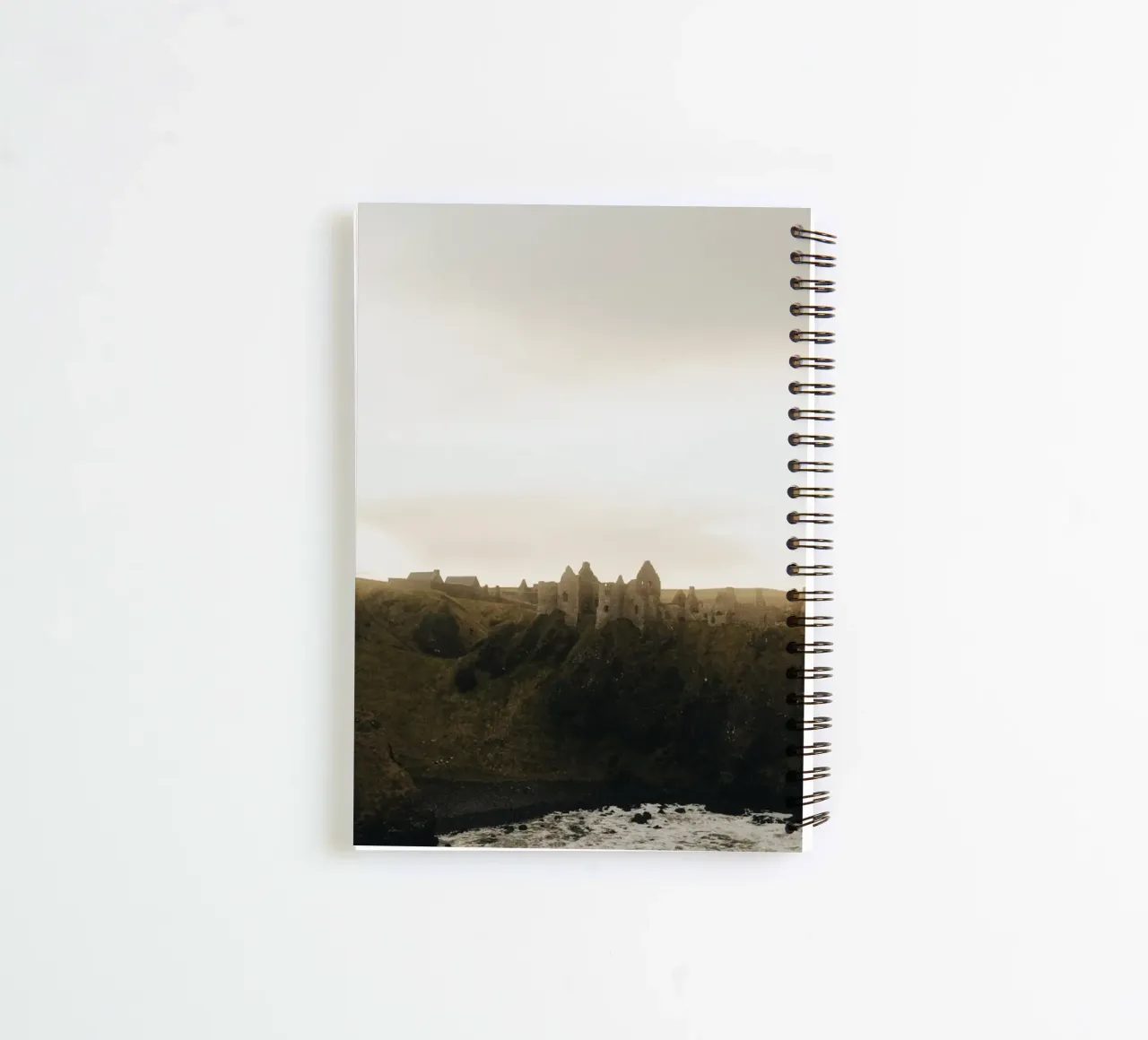 Dunluce Castle im Sonnenuntergang spiral notebook by Stina Freytag
