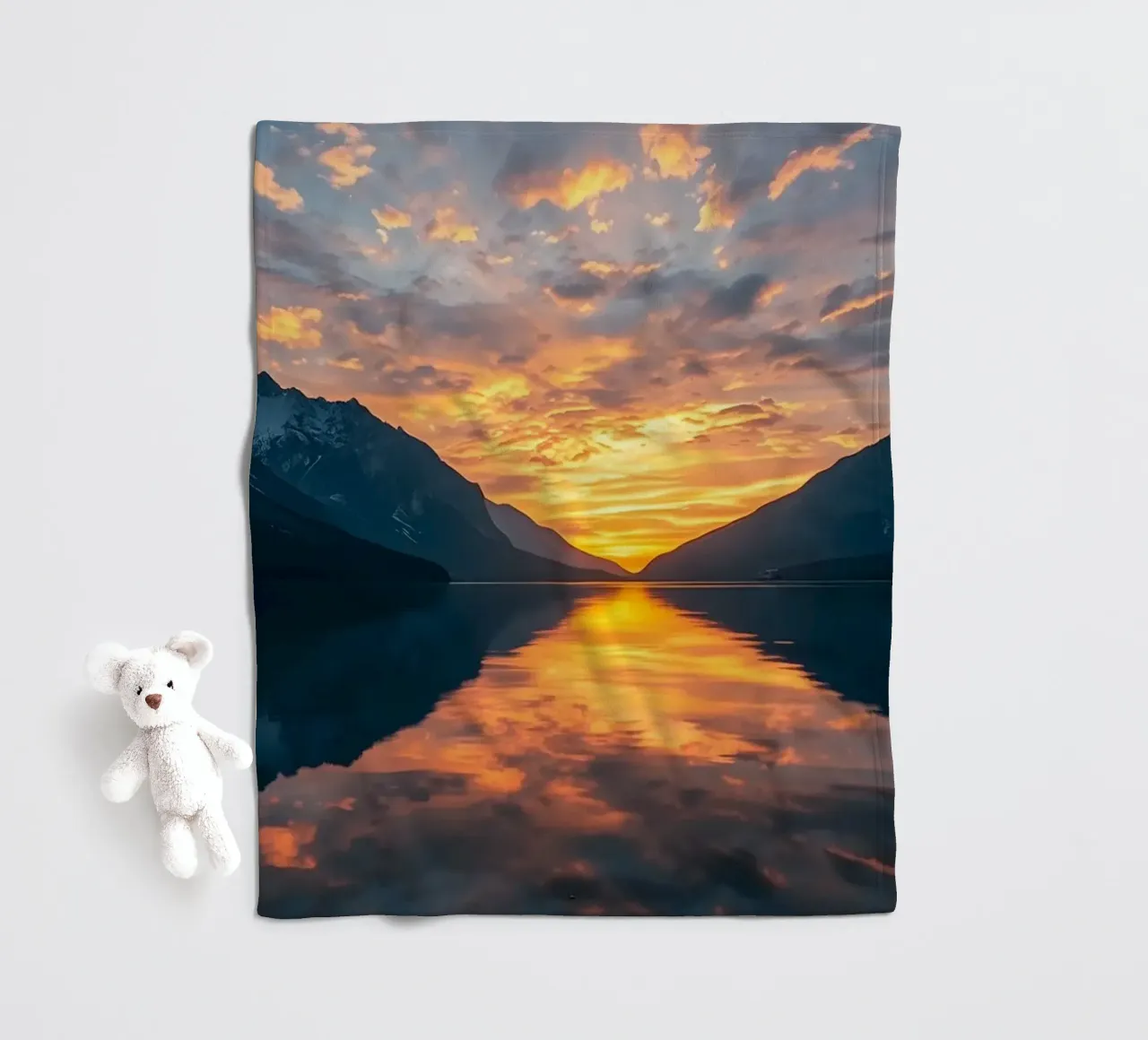 Sunset reflects on calm lake with mountains fleece blanket by DesignDoodle