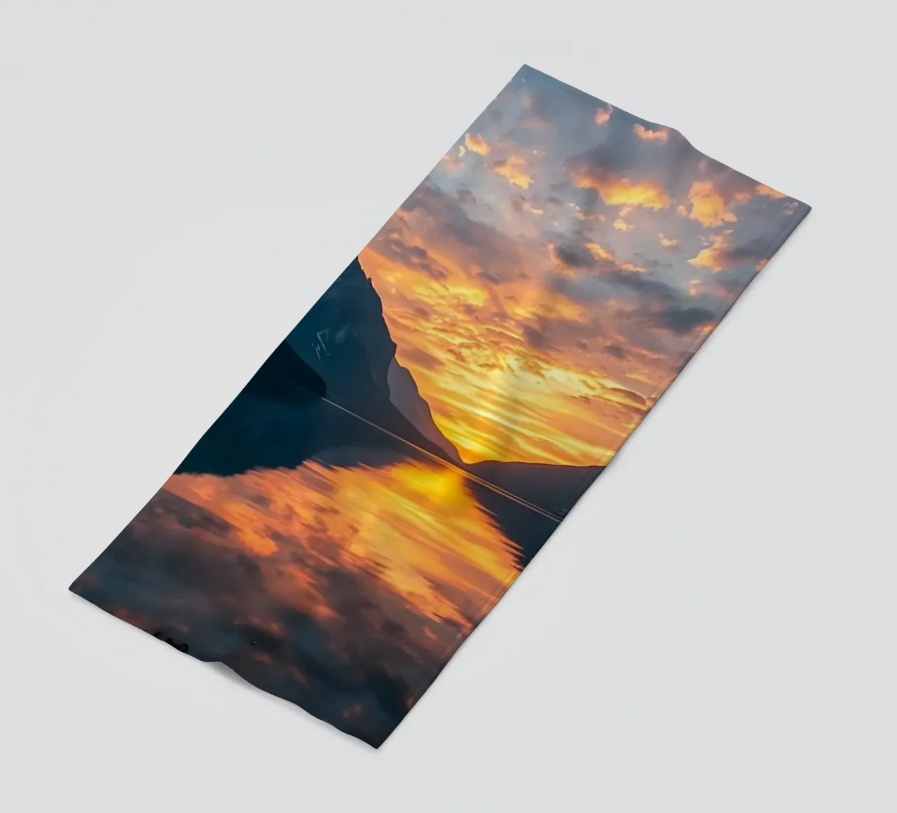 Sunset reflects on calm lake with mountains beach towel by DesignDoodle