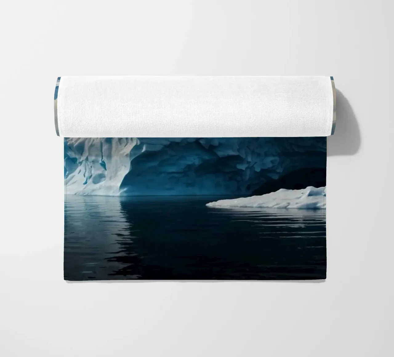 Impressive icebergs reflecting in tranquil waters beach towel by DesignDoodle