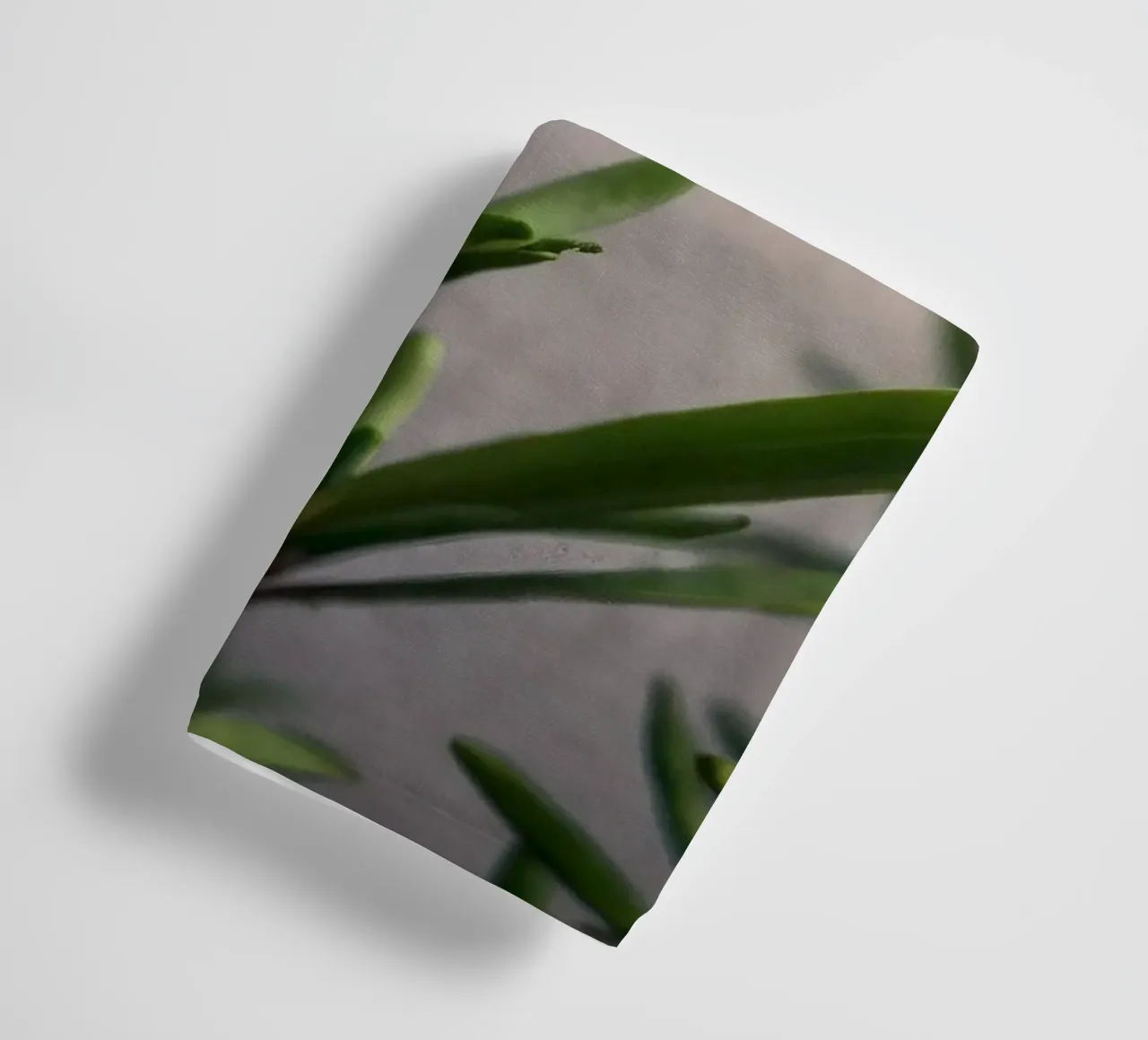 Green plant branches reach upward, showcasing vibrant leaves towel by DesignDoodle