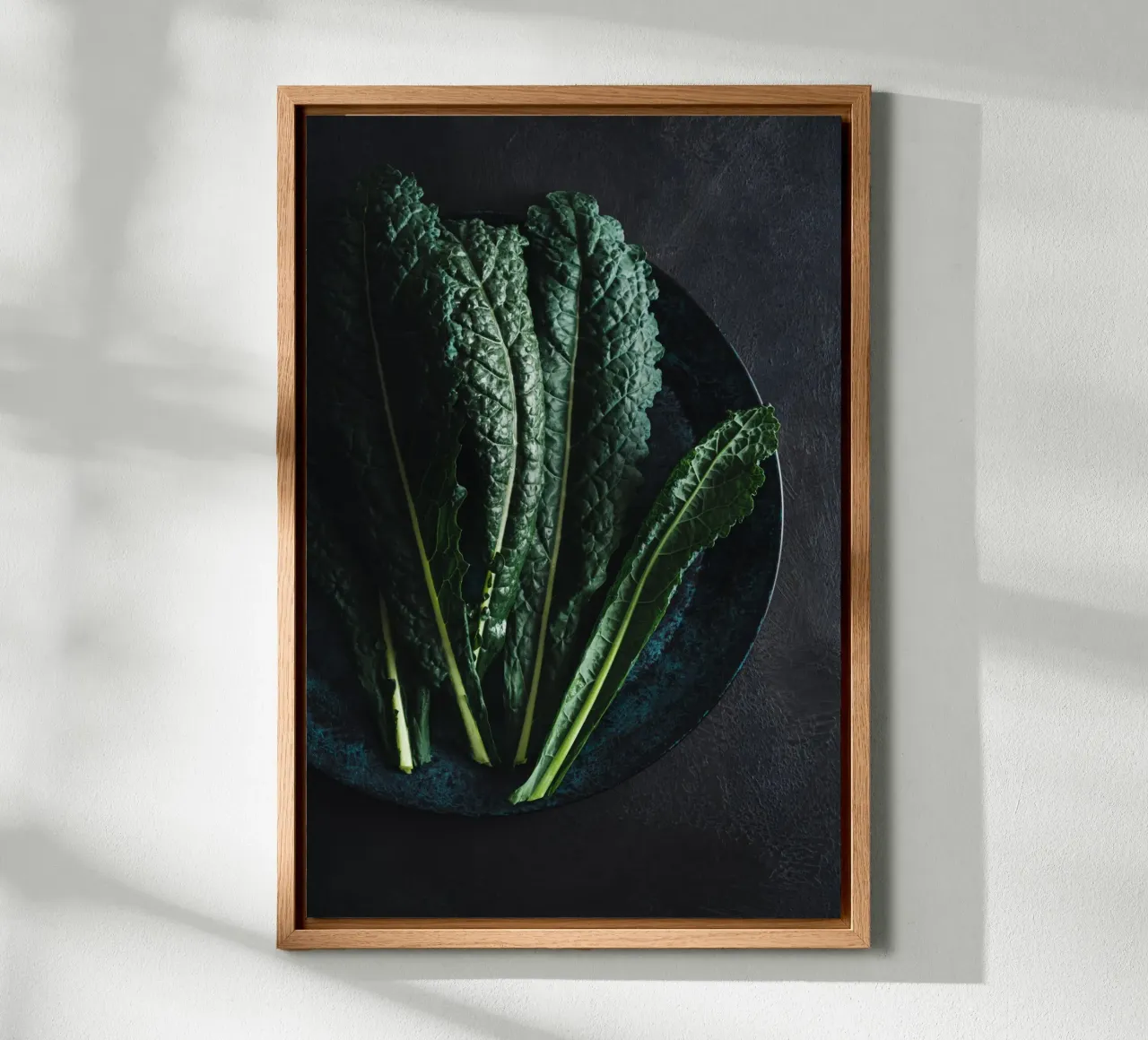 Palm kale leaves on a dark-coloured plate canvas by foodphotolove