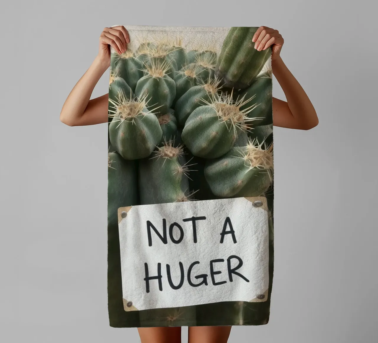 A playful cactus with a humorous sign stands towel by DesignDoodle