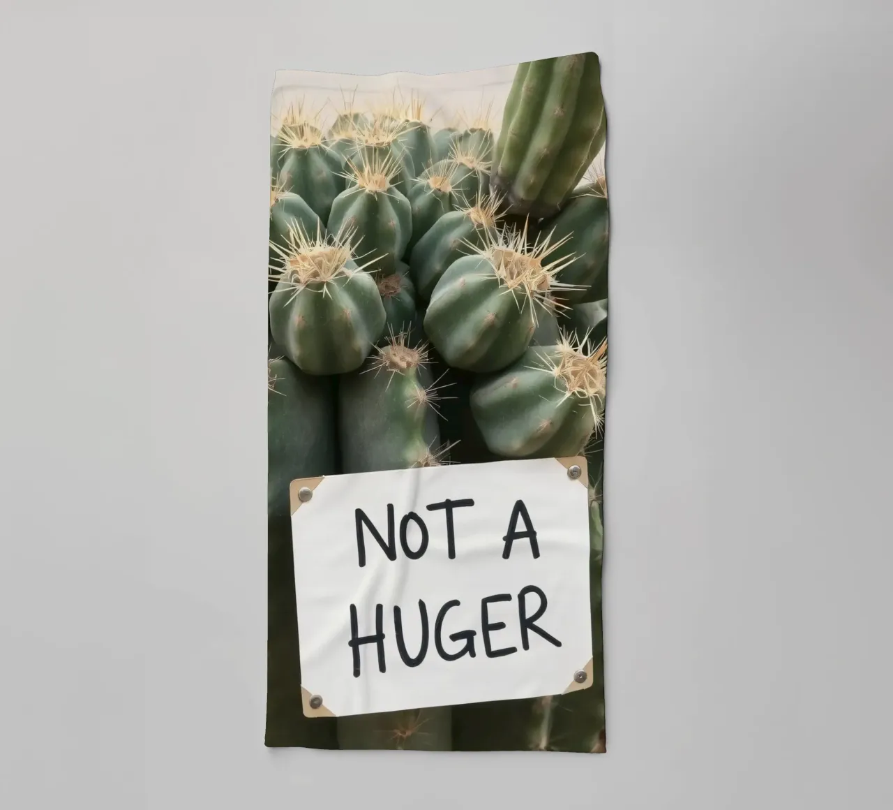 A playful cactus with a humorous sign stands towel by DesignDoodle