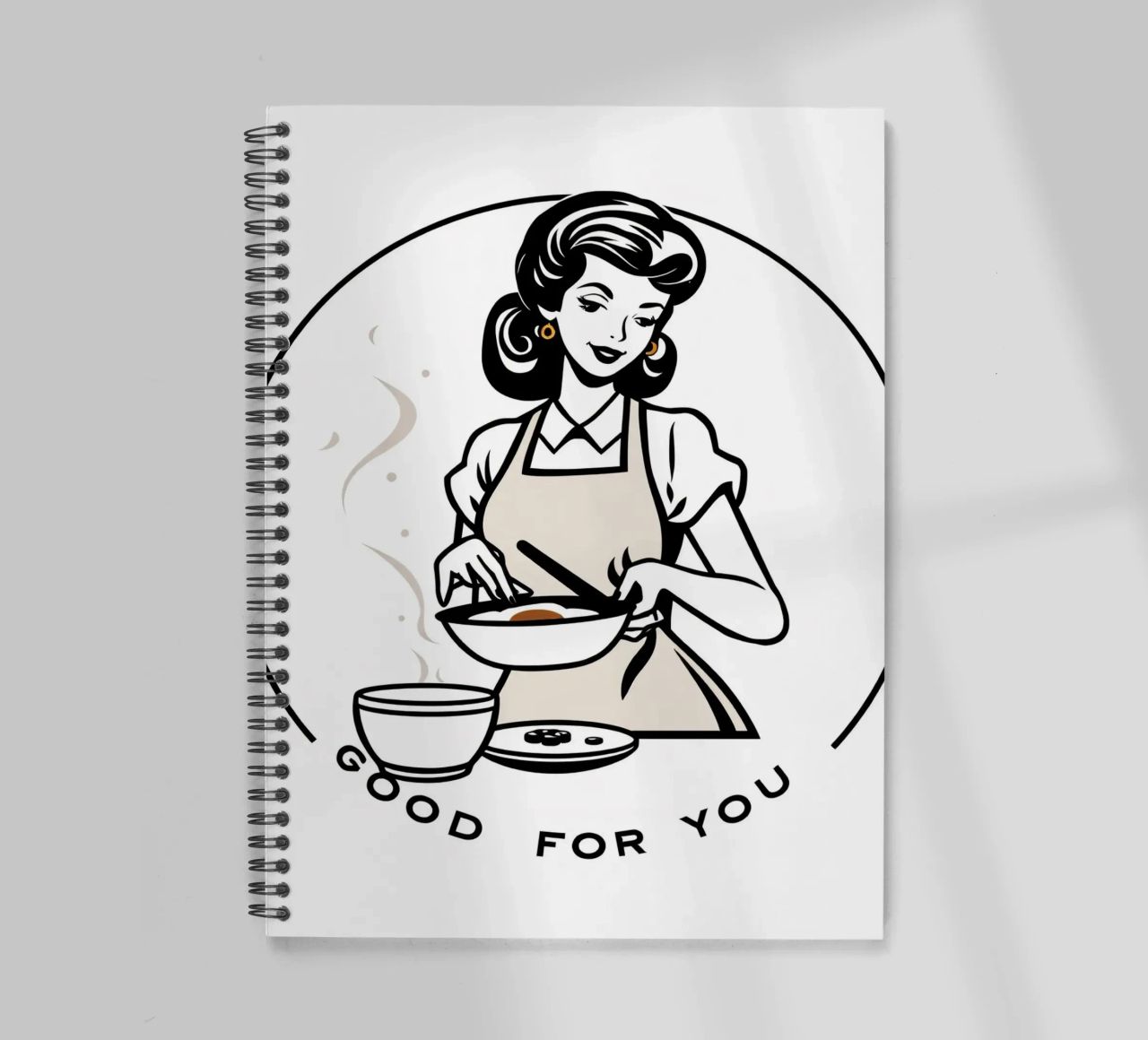 A woman in an apron prepares a meal while smiling spiral notebook by DesignDoodle