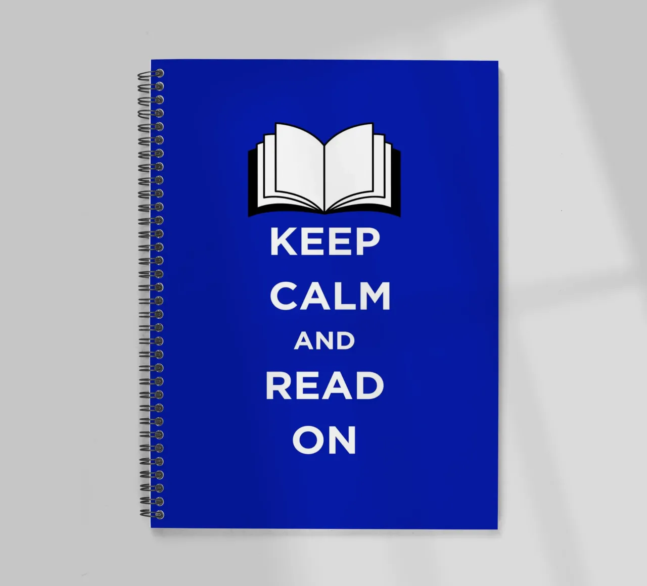 Keep Calm and Read On - Blue Background spiral notebook by FABOArt