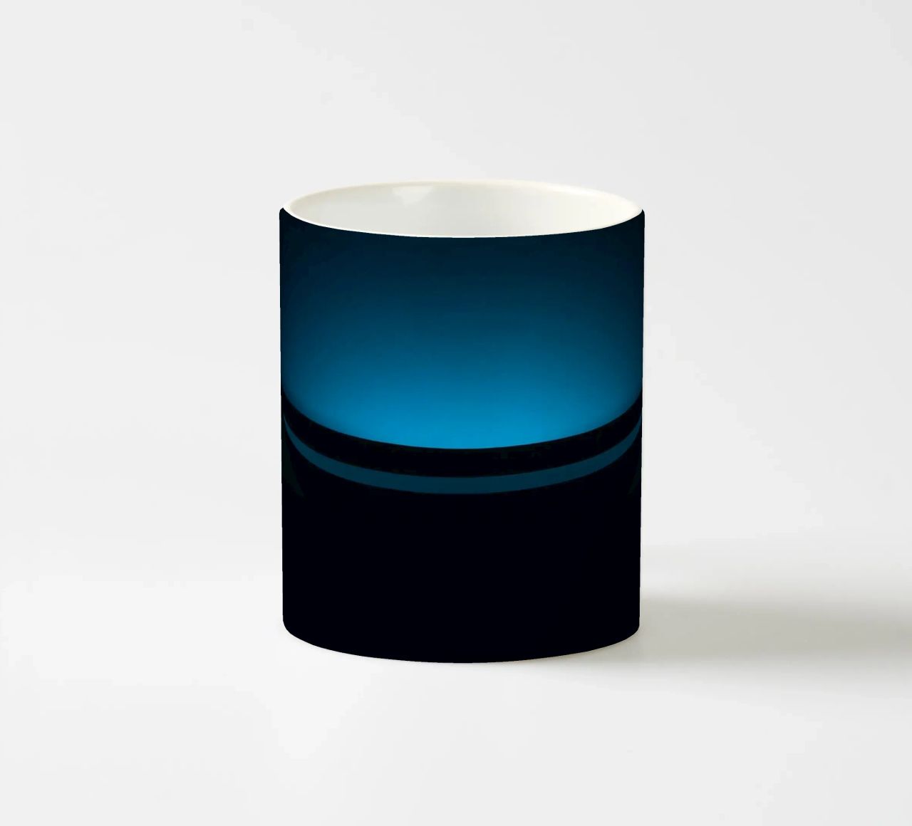 Subtle blue glow illuminating a curved surface in a dark set ceramic mug by DesignDoodle