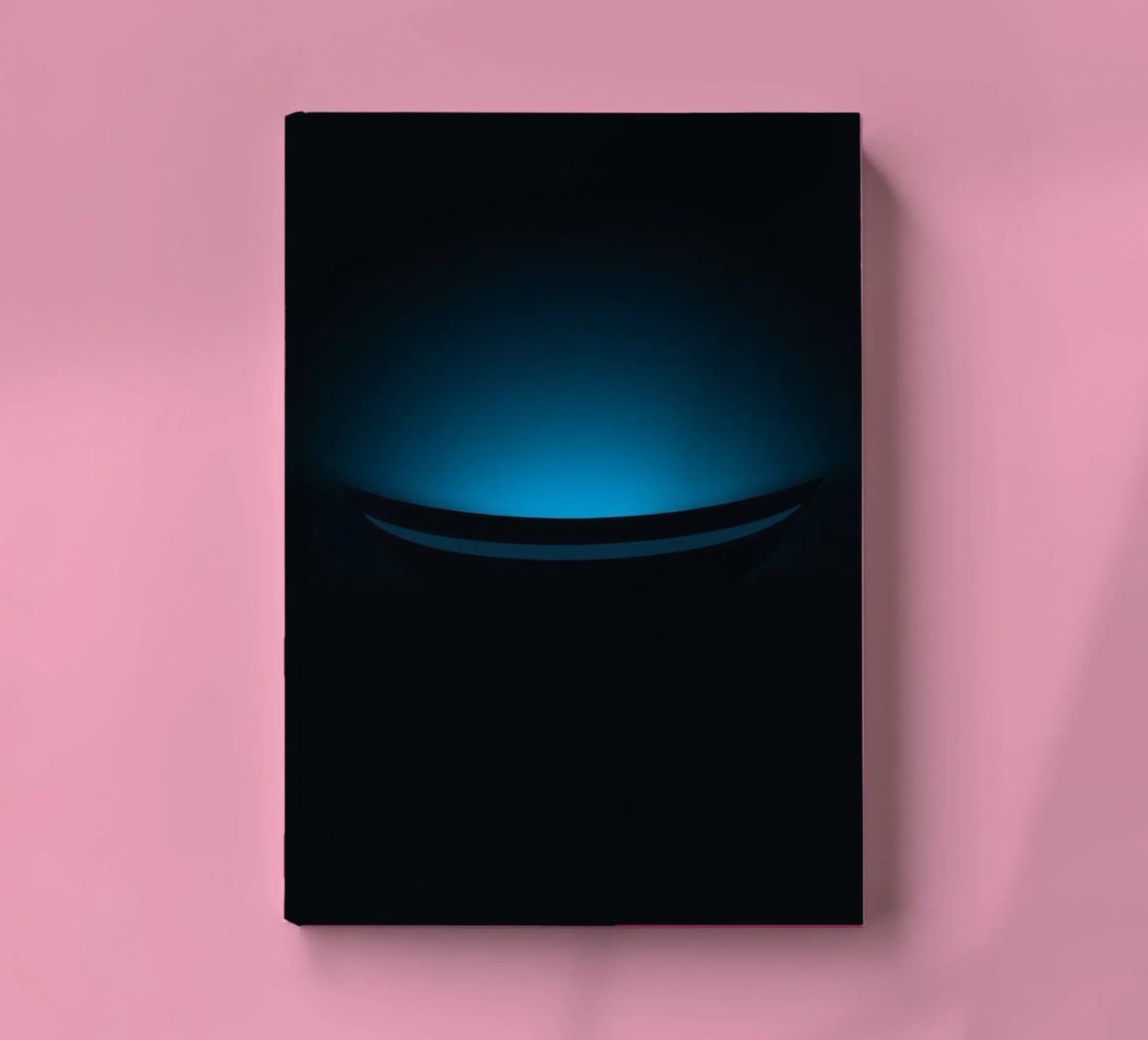 Subtle blue glow illuminating a curved surface in a dark set notebook by DesignDoodle