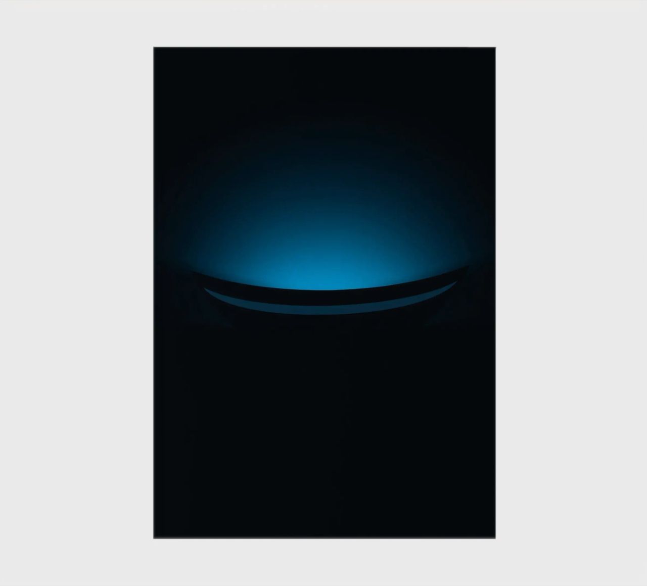 Subtle blue glow illuminating a curved surface in a dark set notebook by DesignDoodle