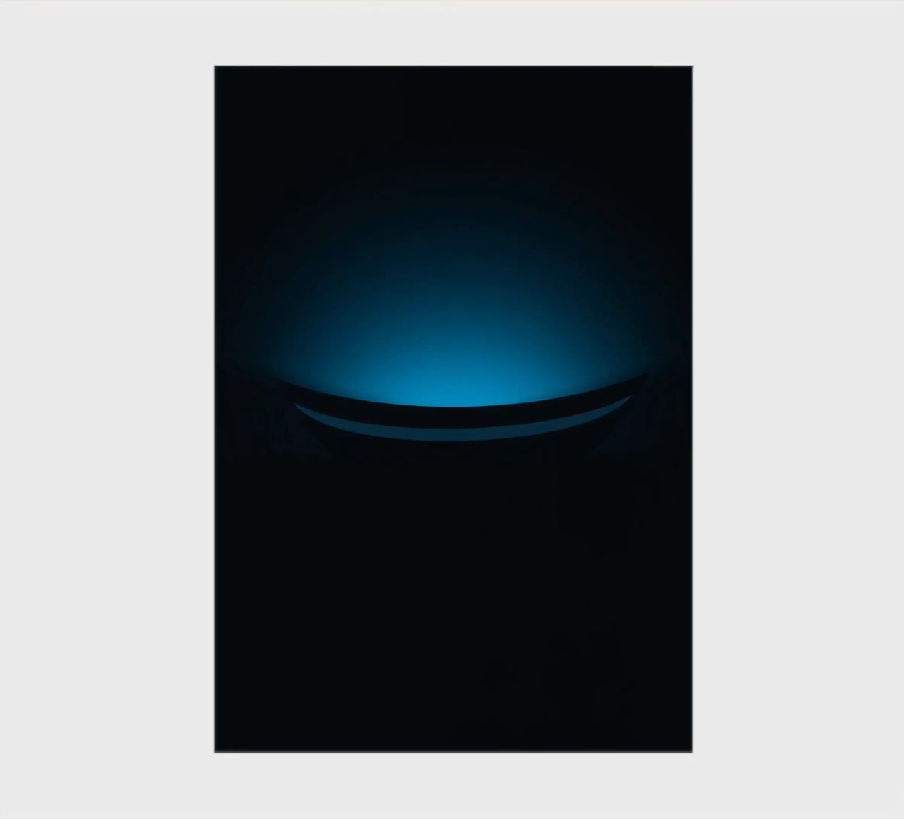 Subtle blue glow illuminating a curved surface in a dark set notebook by DesignDoodle