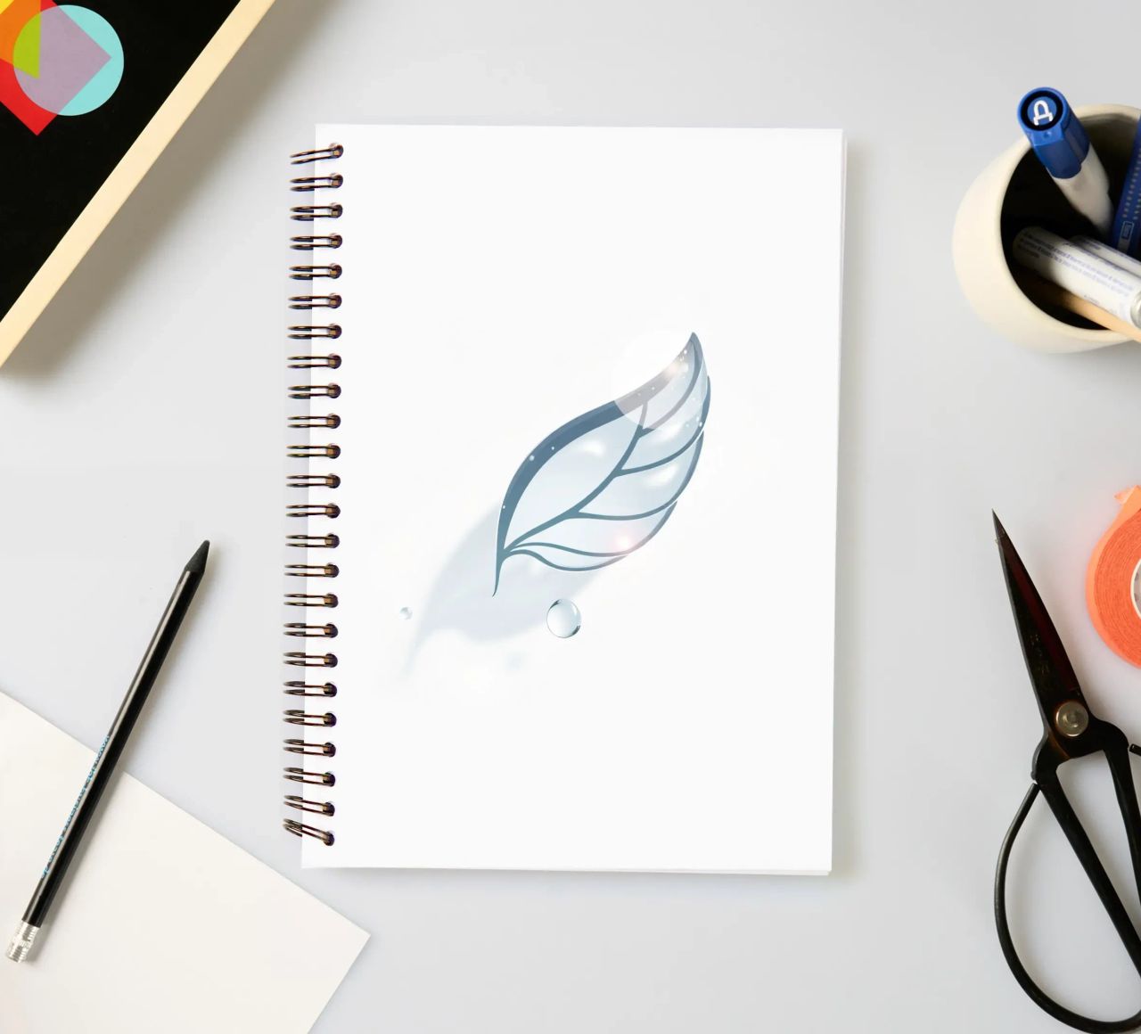 Elegant water droplet resting on a delicate leaf design agai spiral notebook by DesignDoodle
