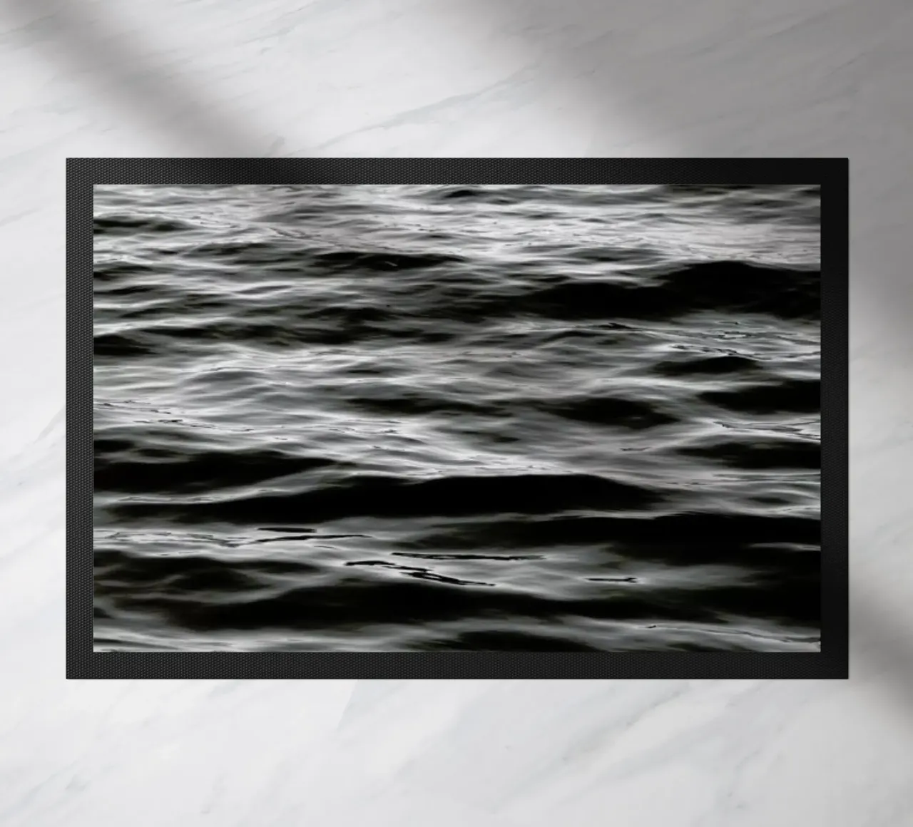 Black Ocean doormat by Studio Nahili